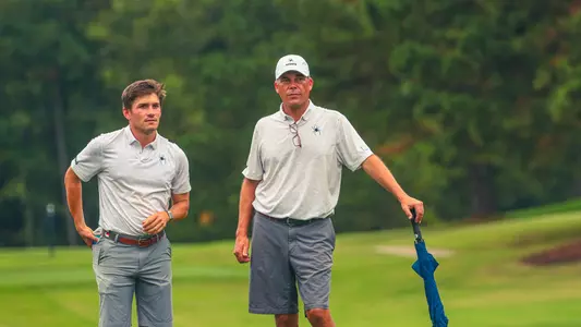 Michael Childress and Adam Decker converse on the fairway