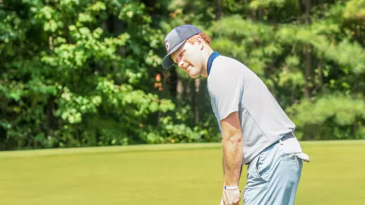 Cole Ekert stares down his putt as it approaches the hole