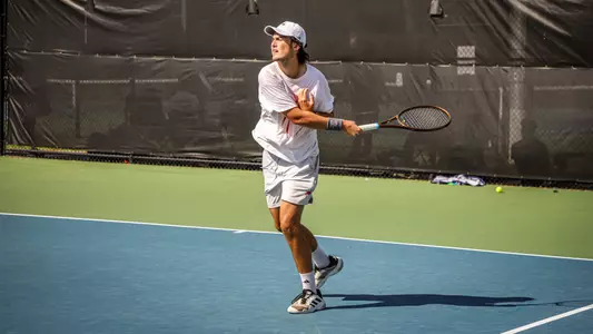 Otto Sewell returning a serve