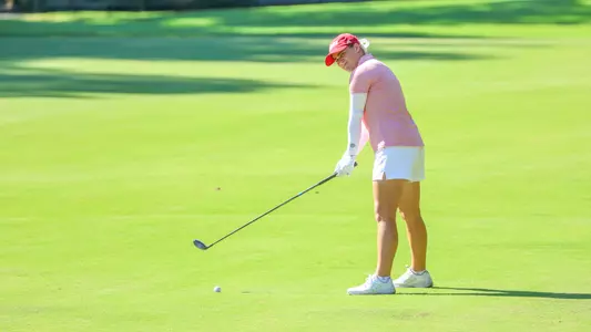Caroline Thompson stands over her ball in the fairway