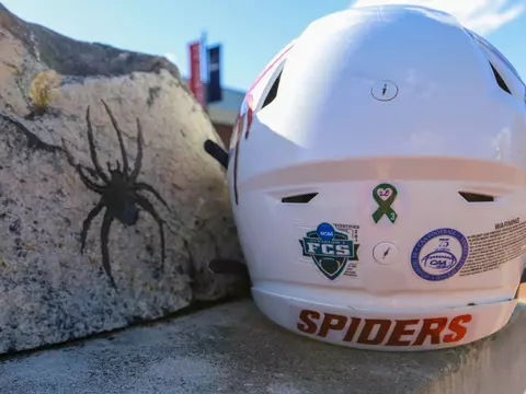 A Spider football helmet next to Spider rock