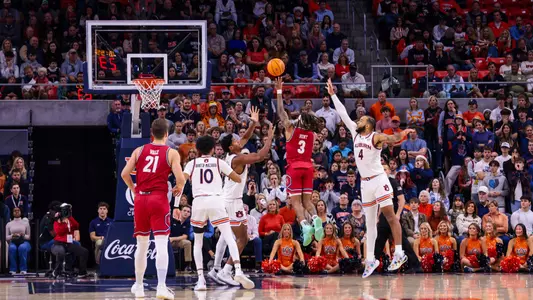 DeLonnie Hunt floats a shot over two Auburn defenders