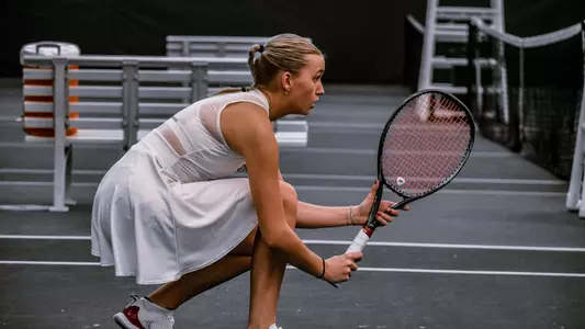 Lainey O'Neil kneeling during a tennis match