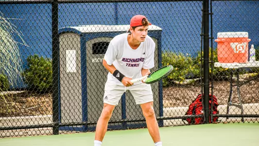 Dylan Atkinson ready to receive a serve in a tennis match