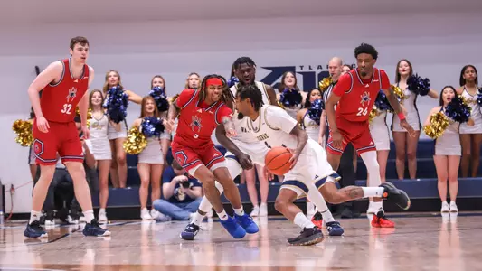 Spiders defenders focus on a GW player driving the ball during a game