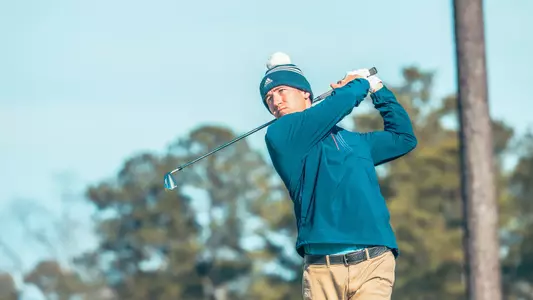 Garrett Clark watches his tee shot and holds his follow through.