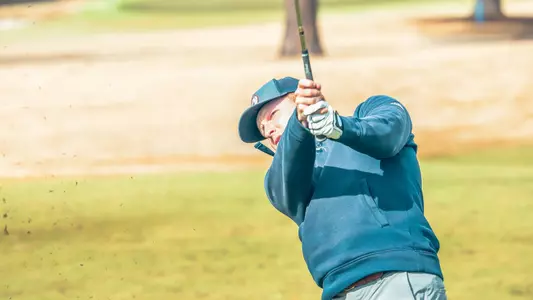 Cole Ekert stares down his approach into the green after hitting a wedge shot
