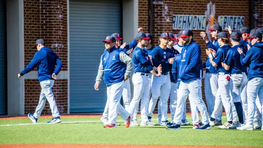 Mik Aoki leaves a pregame baseball team huddle