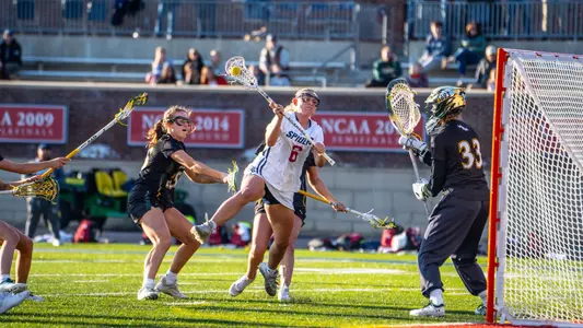 Ali Susskind jumping in the air through multiple defenders shooting a goal