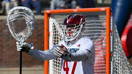 Zach Vigue stands in cage during Richmond's 14-10 loss to Virginia on February 17, 2024