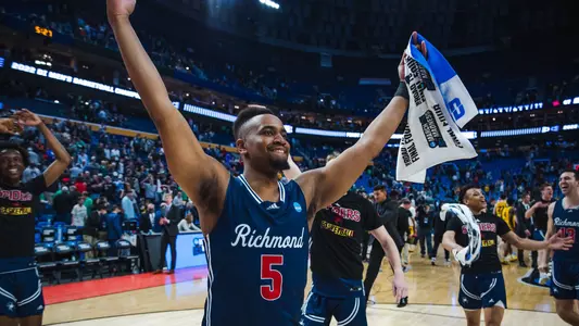 Nick Sherod holds his hands in the air and faces the crowd after Richmond defeated Iowa