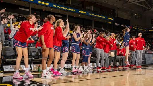 Women's basketball team celebrating a win over VCU