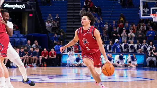 Jordan King looks up at the rim as he drives at Saint Louis