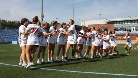 2023 women's lacrosse team going in a line high fiving each other before the game against Marquette in the NCAA Tournament
