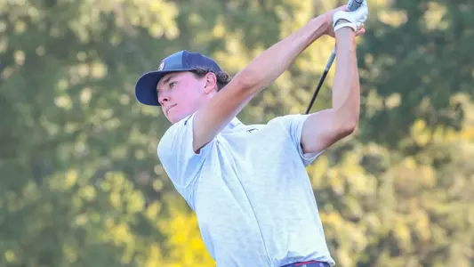 Drew Carlin holds his follow-through after his tee shot