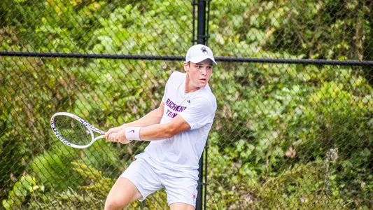Mark Taranov returning a serve during a tennis match