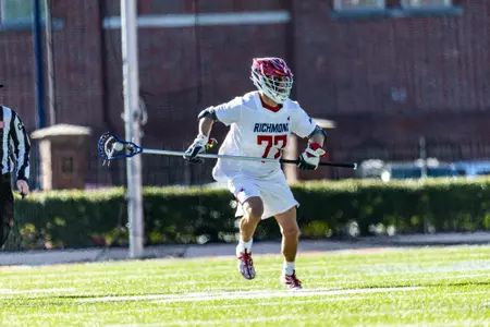 Jack Fabean carries the ball downfield during Richmond's 12-11 loss to Maryland, Feb. 3, 2024