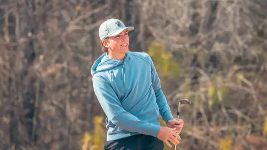 Parker Moellinger watches his wedge shot approach the green