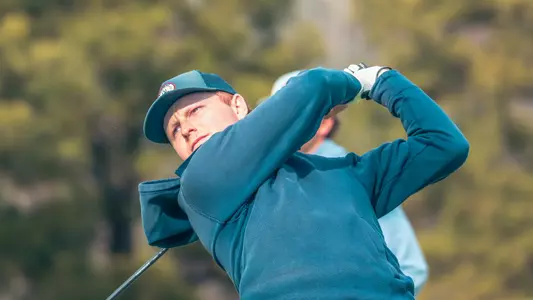 Cole Ekert watches his drive on the tee box