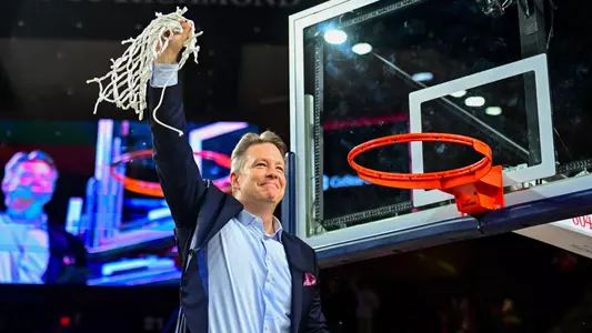 Chris Mooney holds up the net after cutting it off the rim at the Robins Center following Richmond's win vs Saint Joseph's, which clinched the A-10 regular season title.