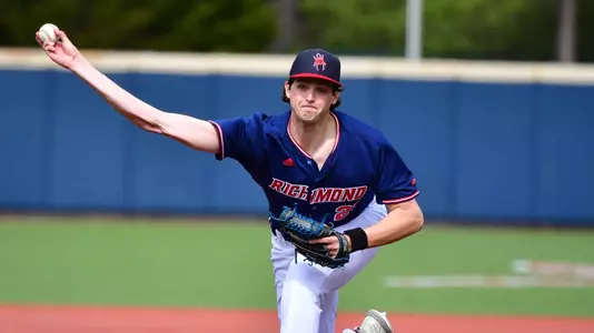 Kyle Roche releases the ball towards the plate from the pitchers mound.