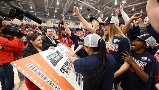 Players putting the spider on the ticket punched poster