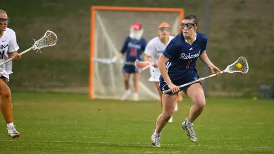 Caroline Murphy bringing the ball up the field in a clear attempt, a Virginia defender is to her right side
