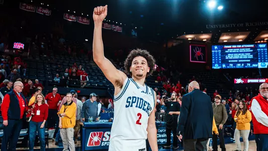 Jordan King raises a hand in a victory salute after leading the Spiders to a win over VCU