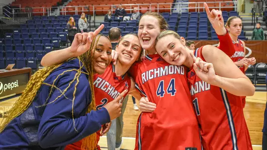 Photo of Maggie Doogan, Torin Rogers, Jada Green celebrating the A10 win