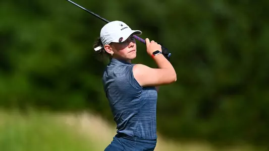 Hannah Lydic holds her follow-through and stares down her tee shot