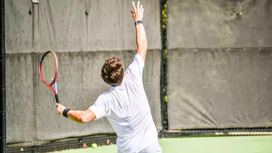 Nick Roddy serving a tennis ball
