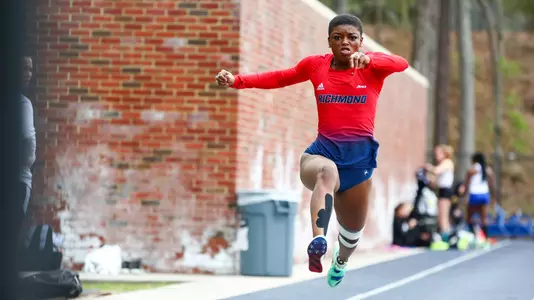Alicia Dawson stares straight ahead while jumping in the triple jump