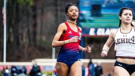 Kamyah Wright close up crossing the finish line looking at the camera