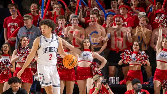 Jordan King dribbles in front of the Spiders student section during a game vs VCU