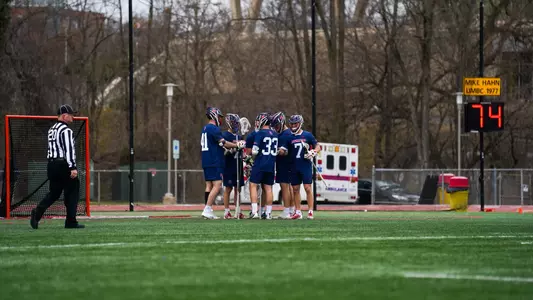 The men's lacrosse team huddles on the field at UMBC Stadium during Richmond's 13-4 win over UMBC on Friday, March 8, 2024/