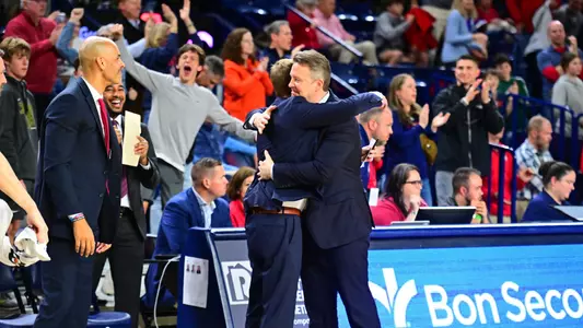 Chris Mooney and Will Gipe embrace at the end of a Spiders win