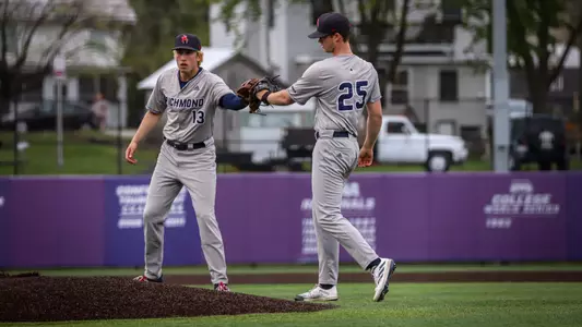 Jordan Jaffe taps gloves with pitcher Ethan Sannes prior to the start of the inning