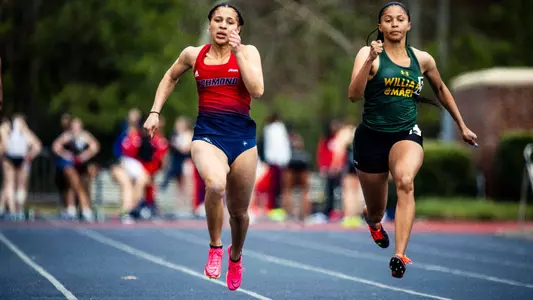 Nina Lavelle running in a sprint event with a competitor to her left