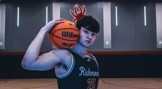 Jonathan Beagle holds a ball on his right shoulder and stares into the camera