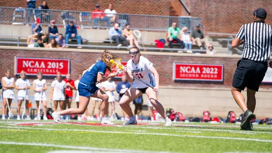 Clare McCooe going against a George Washington player in the draw circle