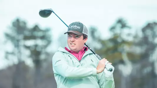 Quin Polin holds his club on his shoulder while watching his tee shot