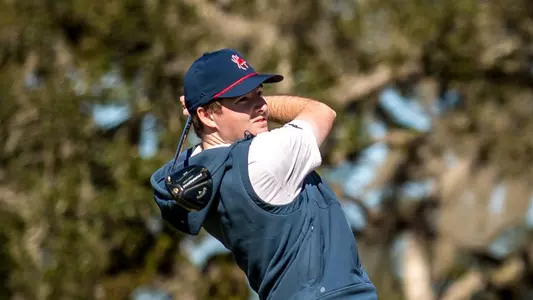 Quin Polin holds his follow through and stares at his tee shot