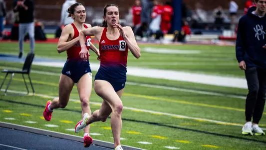 Elizabeth Stockman with teammate Madison Trippett directly behind her about to cross the finish line at a track event