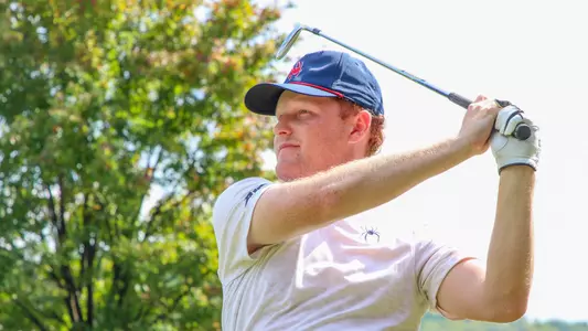 Cole Ekert holds his follow-through and watches his tee shot