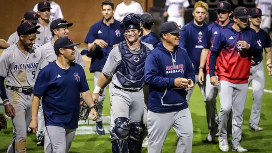 Head Coach Mik Aoki and the baseball team are smiling after defeating Longwood on the road.