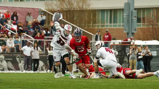 Jared Chenoy fights for a loose ball during a face off at UMass' Garber Field on Saturday, April 20, 2024