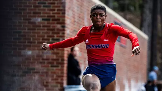 Alicia Dawson mid jump during the triple jump with a determined face