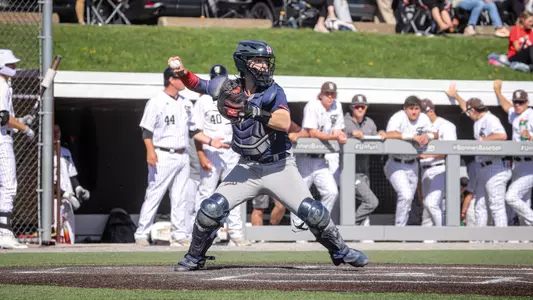 Zach Lass throws the ball down to second to practice throwing out runners