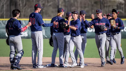 The Baseball team high fives each other after defeating St. Bonaventure