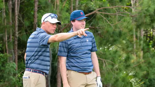 Adam Decker points out something on the hole to Quin Polin
